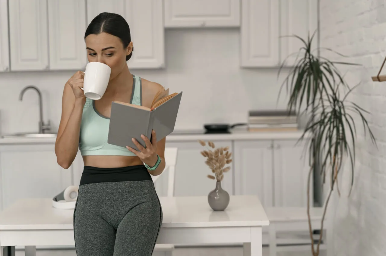 Woman reading while drinking coffee