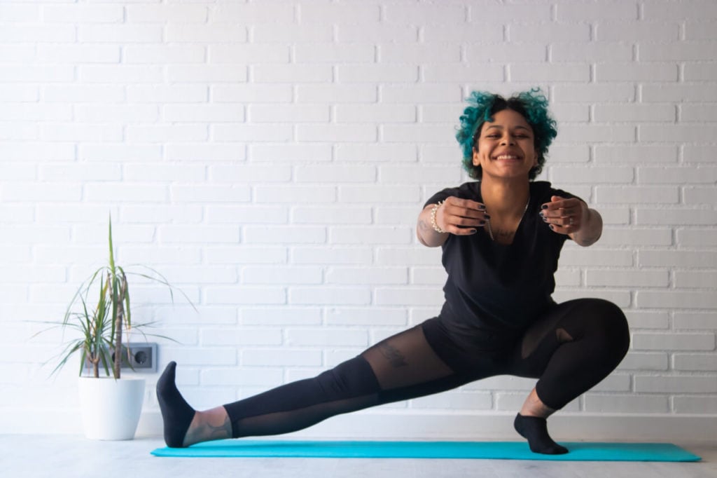 Yoga instructor smiling while teaching class