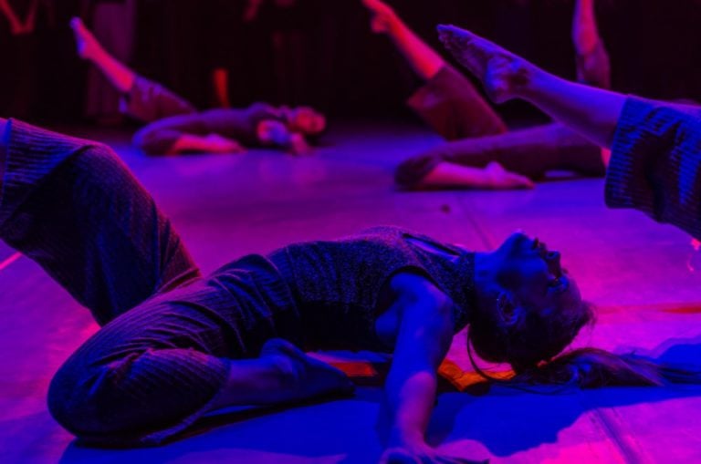 Dance class under pink and blue lights