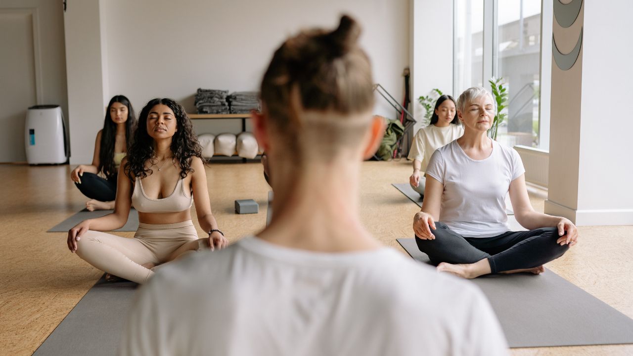 Yoga instructor leading class in meditation