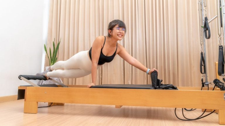 Pilates student on pilates reformer