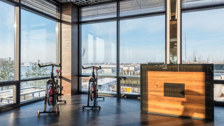 Stationary bikes next to check in desk at gym