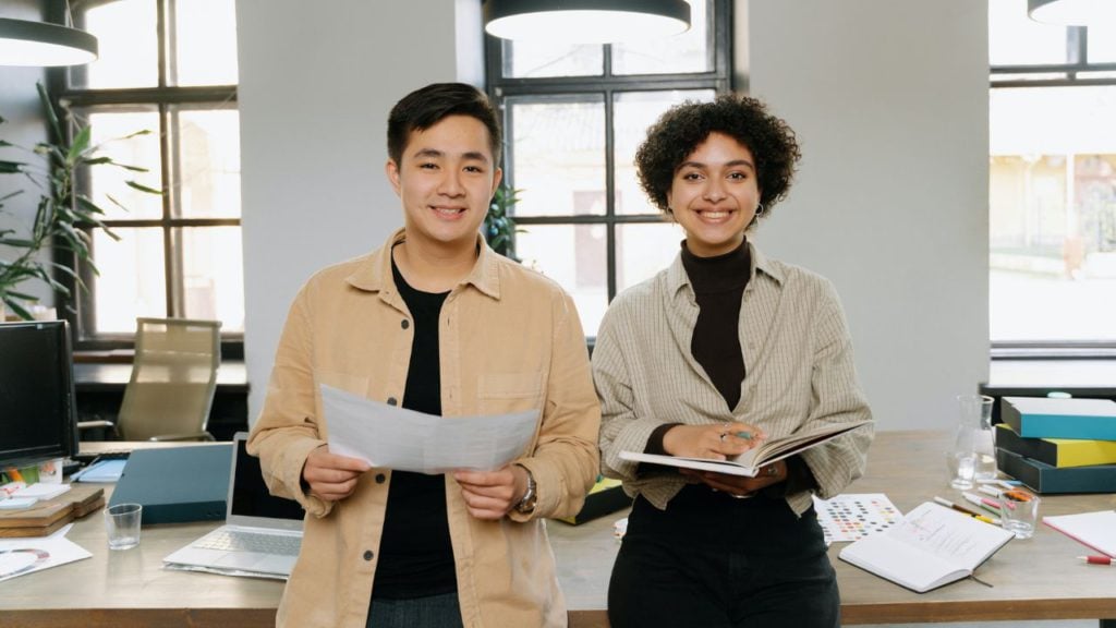 Entrepreneurs posing in front of large worktable