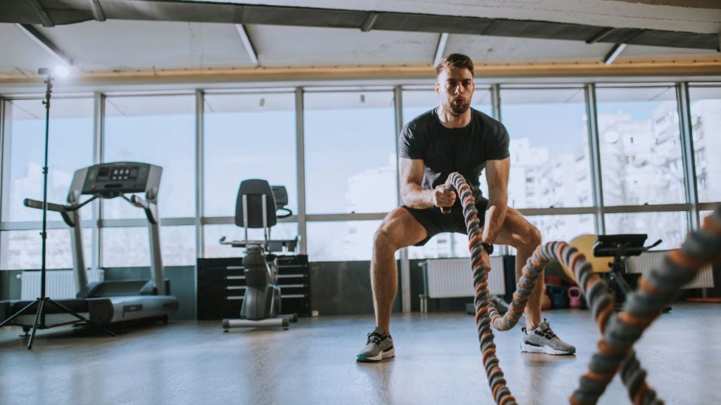 Client working on battle ropes exercise